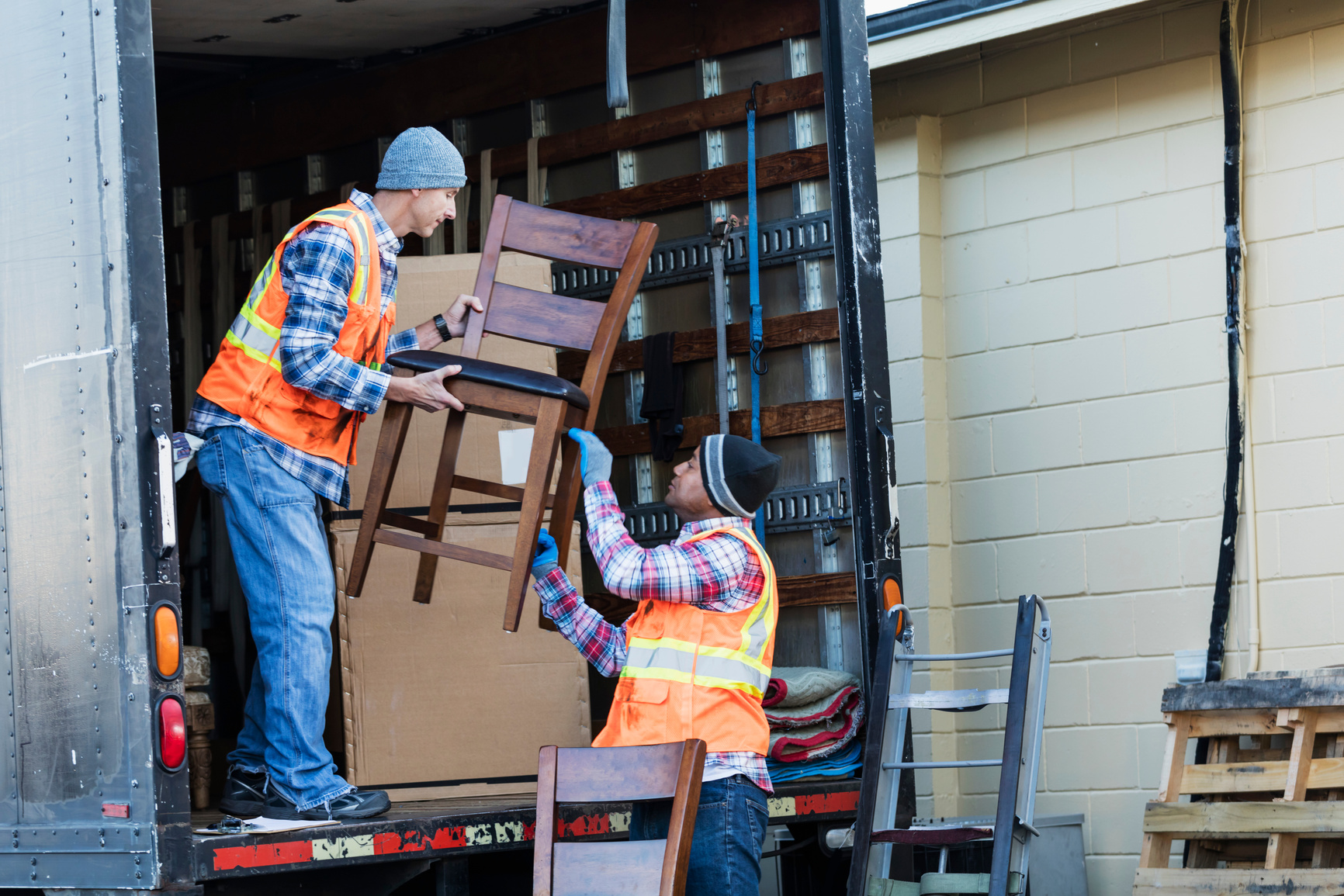 Two workers with a truck, moving furniture